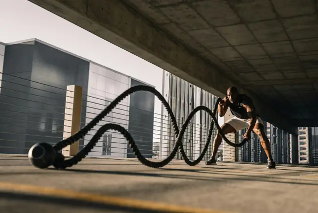 Man training with battle ropes