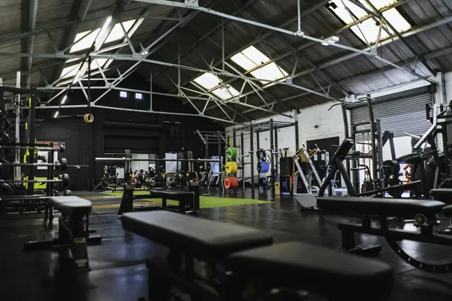 Industrial gym floor with benches, racks and free weights