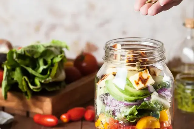 Meal prep salad in a glass jar with fresh vegetables