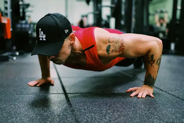 Man doing a push-up on a gym floor