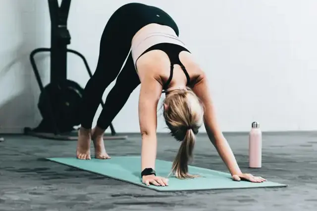 Woman stretching in a downward dog position on a mat
